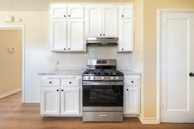 2744 E Michigan Ave, Fresno, CA 93703 - kitchen featuring gas stove, baseboards, white cabinets, and under cabinet range hood