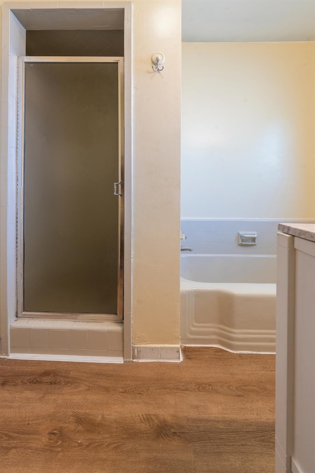 2744 E Michigan Ave, Fresno, CA 93703 - full bathroom with a shower stall, wood finished floors, and a garden tub