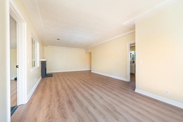 2744 E Michigan Ave, Fresno, CA 93703 - unfurnished living room featuring light wood-style flooring and baseboards