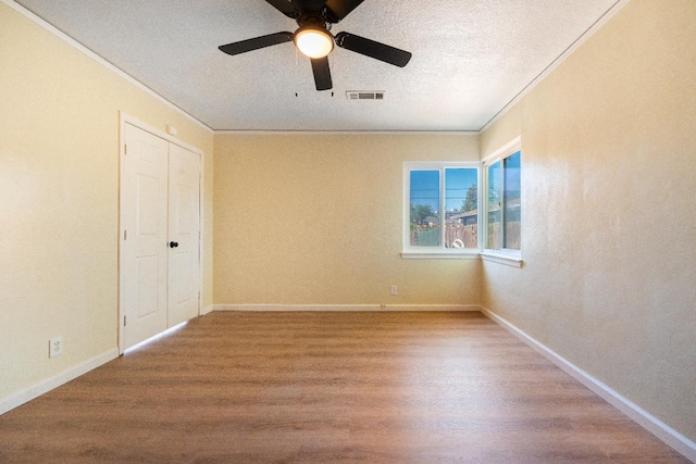 2744 E Michigan Ave, Fresno, CA 93703 - unfurnished bedroom featuring ornamental molding, wood finished floors, baseboards, a ceiling fan, and a textured ceiling