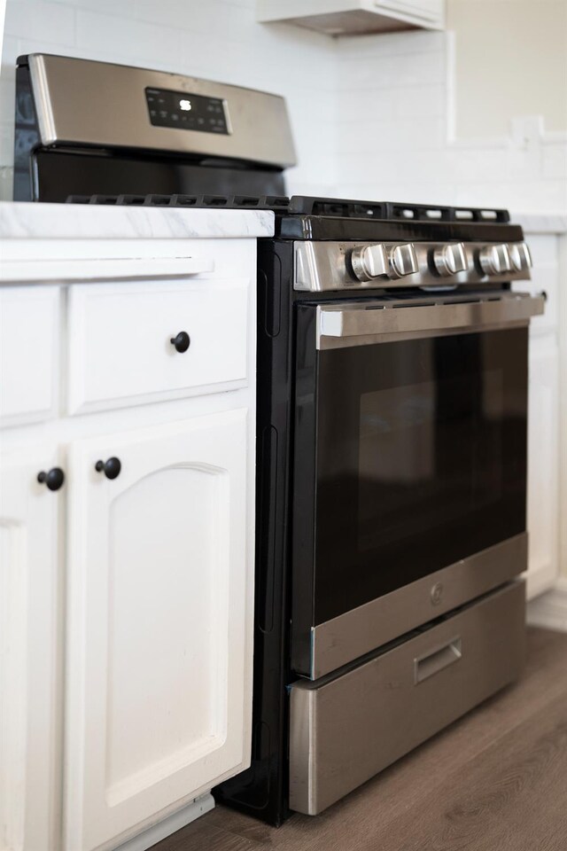 2744 E Michigan Ave, Fresno, CA 93703 - kitchen view of white cabinetry, wood finished floors, and gas range