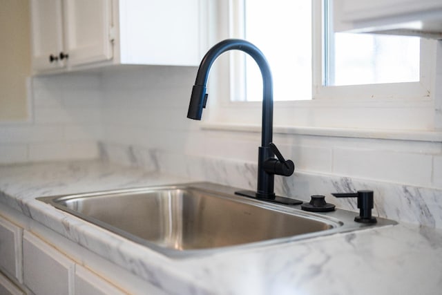 2744 E Michigan Ave, Fresno, CA 93703 - kitchen view of a sink, tasteful backsplash, white cabinets, and light countertops