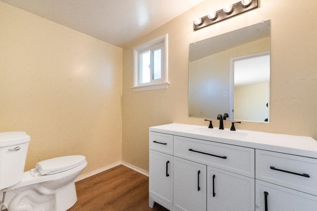 2744 E Michigan Ave, Fresno, CA 93703 - bathroom with toilet, vanity, wood finished floors, and baseboards