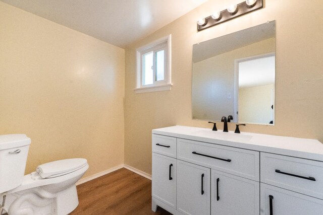 2744 E Michigan Ave, Fresno, CA 93703 - bathroom with toilet, vanity, wood finished floors, and baseboards