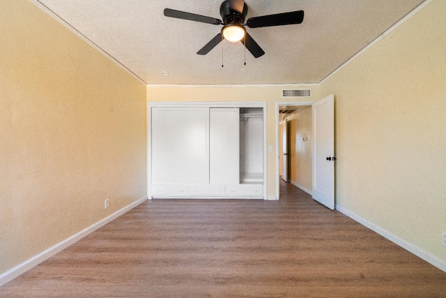 2744 E Michigan Ave, Fresno, CA 93703 - unfurnished bedroom featuring wood finished floors, ornamental molding, a closet, baseboards, and a ceiling fan