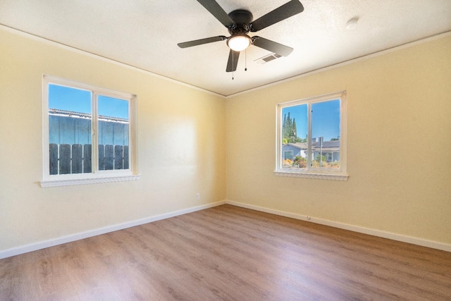 2744 E Michigan Ave, Fresno, CA 93703 - unfurnished room featuring wood finished floors, crown molding, healthy amount of natural light, and baseboards