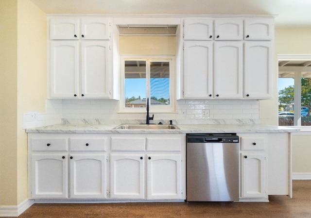 2744 E Michigan Ave, Fresno, CA 93703 - kitchen with stainless steel dishwasher, a sink, white cabinetry, and decorative backsplash