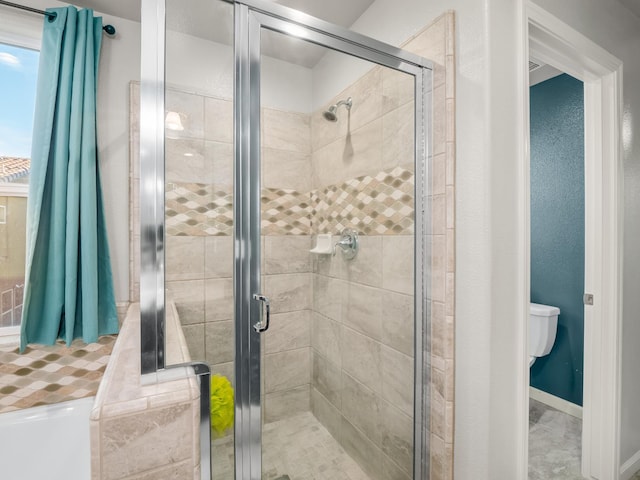 6053 E Brick Dr, Fresno, CA 93727 - bathroom featuring a stall shower and toilet