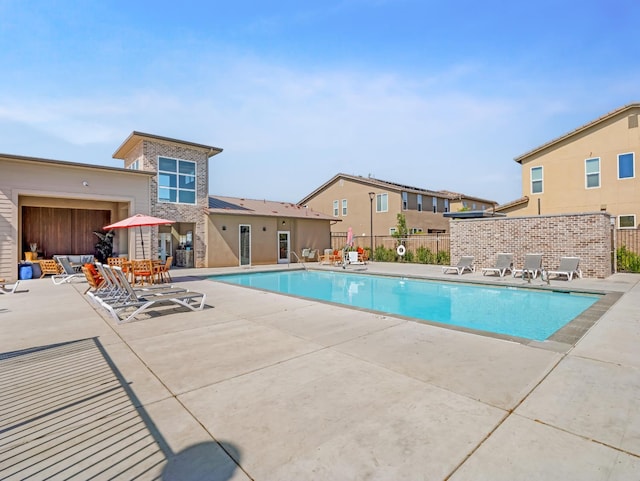 6053 E Brick Dr, Fresno, CA 93727 - community pool featuring a patio area