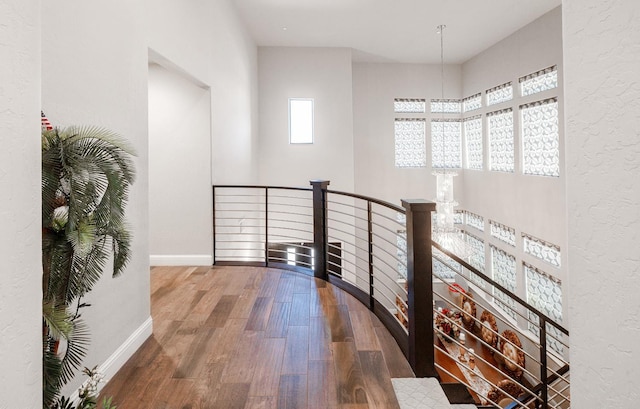 5615 N Lucy Ruiz Ave, Fresno, CA 93723 - hallway with an upstairs landing, wood finished floors, and baseboards