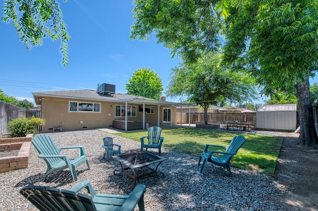 4461 N Winery Ave, Fresno, CA 93726 - rear view of house featuring a fire pit, a hot tub, a patio, and central air condition unit
