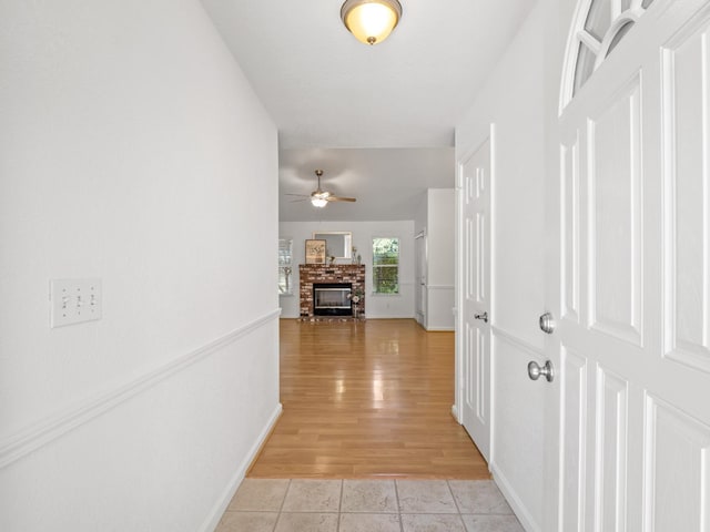 6185 N Milburn Ave, Fresno, CA 93722 - hallway featuring light tile patterned floors and baseboards