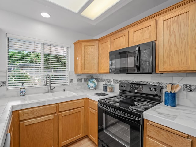 6185 N Milburn Ave, Fresno, CA 93722 - kitchen with black appliances, a sink, light countertops, and decorative backsplash