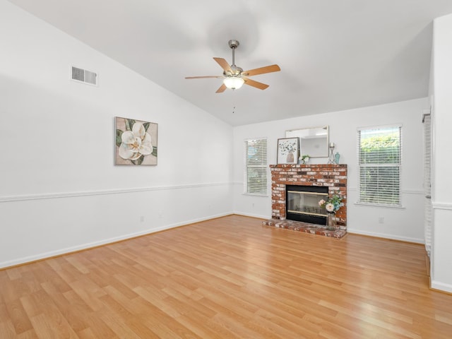 6185 N Milburn Ave, Fresno, CA 93722 - unfurnished living room with light wood-style floors, ceiling fan, a fireplace, baseboards, and high vaulted ceiling