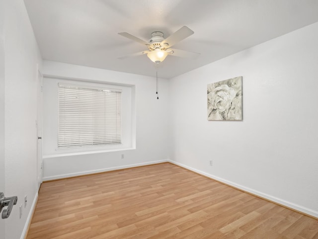 6185 N Milburn Ave, Fresno, CA 93722 - spare room with light wood-style floors, ceiling fan, and baseboards