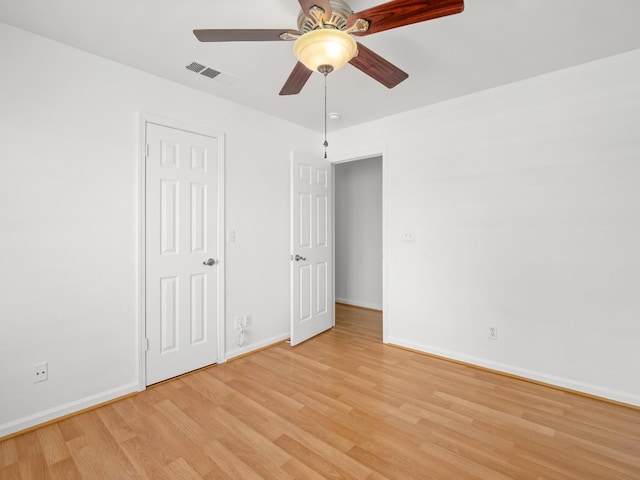 6185 N Milburn Ave, Fresno, CA 93722 - unfurnished bedroom with light wood finished floors and baseboards