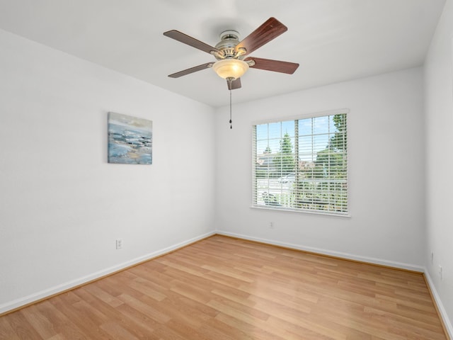 6185 N Milburn Ave, Fresno, CA 93722 - unfurnished room with light wood finished floors, baseboards, and a ceiling fan