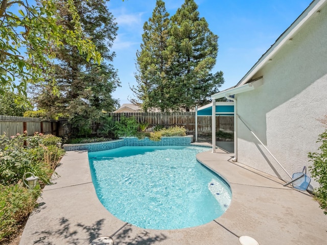 6185 N Milburn Ave, Fresno, CA 93722 - view of swimming pool featuring a fenced backyard and a patio area