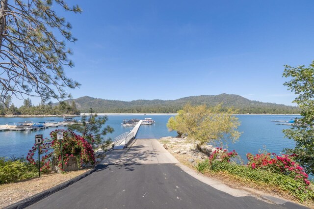 37731 Shoreline Dr, Bass Lake, CA 93604 - water view featuring mountains and a boat dock
