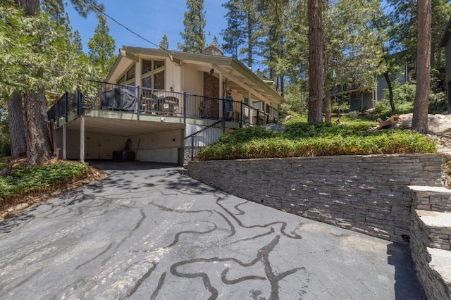 37731 Shoreline Dr, Bass Lake, CA 93604 - view of front of property with asphalt driveway, a carport, and stairs