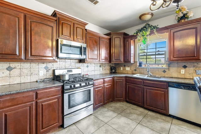 42462 Rd 140, Orosi, CA 93647 - kitchen with appliances with stainless steel finishes, a sink, light tile patterned floors, and backsplash