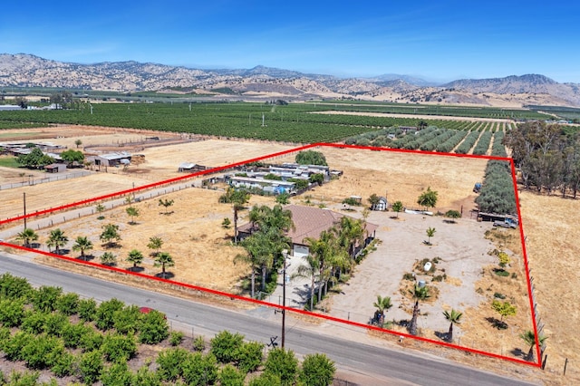 42462 Rd 140, Orosi, CA 93647 - aerial view of sparsely populated area featuring farmland, property parcel outlined, and a mountain backdrop
