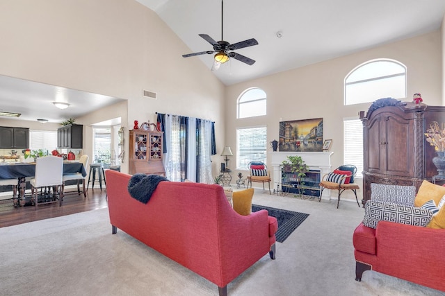 1775 E Cole Ave, Fresno, CA 93720 - carpeted living room featuring high vaulted ceiling, a ceiling fan, a glass covered fireplace, and plenty of natural light