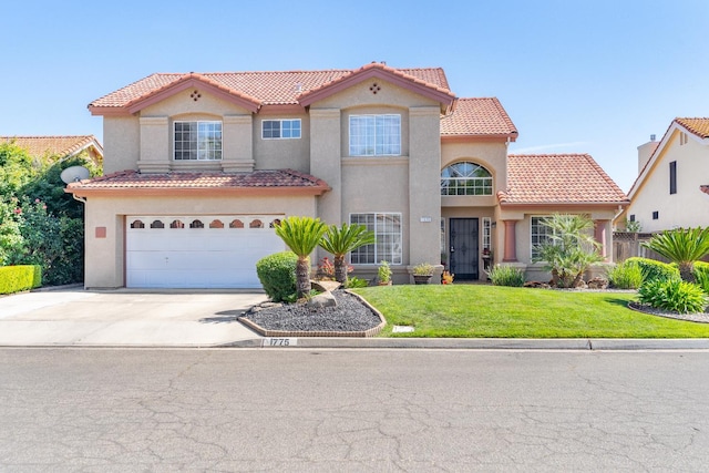 1775 E Cole Ave, Fresno, CA 93720 - mediterranean / spanish home featuring a tile roof, driveway, a garage, a front yard, and stucco siding