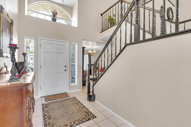 1775 E Cole Ave, Fresno, CA 93720 - foyer entrance featuring healthy amount of natural light, stairway, light tile patterned floors, baseboards, and a towering ceiling