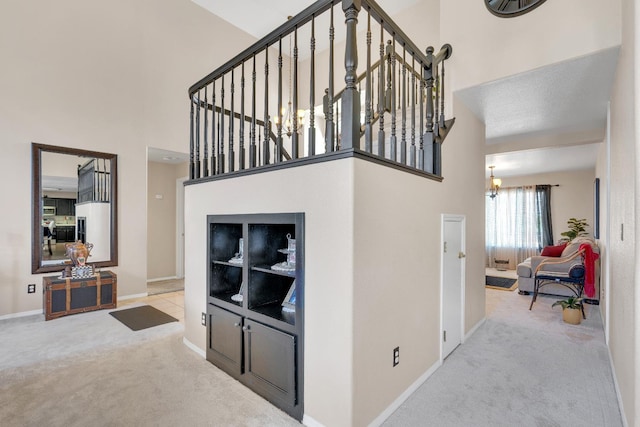 1775 E Cole Ave, Fresno, CA 93720 - staircase featuring carpet floors, a towering ceiling, a chandelier, and baseboards