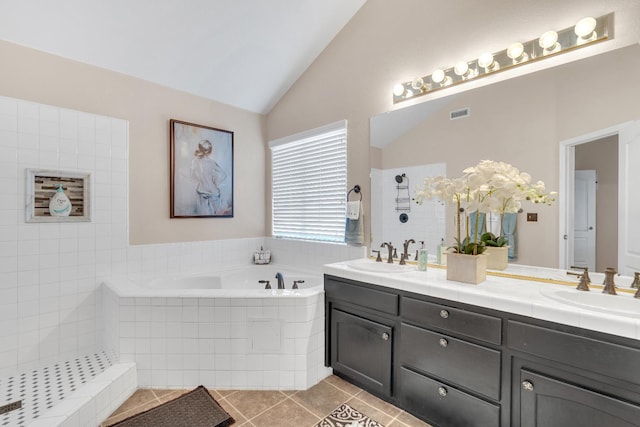 1775 E Cole Ave, Fresno, CA 93720 - bathroom featuring vaulted ceiling, double vanity, tile patterned flooring, a bath, and tiled shower