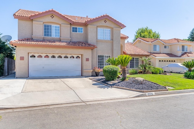 1775 E Cole Ave, Fresno, CA 93720 - mediterranean / spanish house featuring a tile roof, stucco siding, an attached garage, and concrete driveway