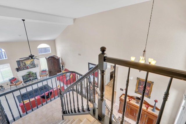 1775 E Cole Ave, Fresno, CA 93720 - staircase featuring a ceiling fan, beam ceiling, a chandelier, a fireplace, and high vaulted ceiling