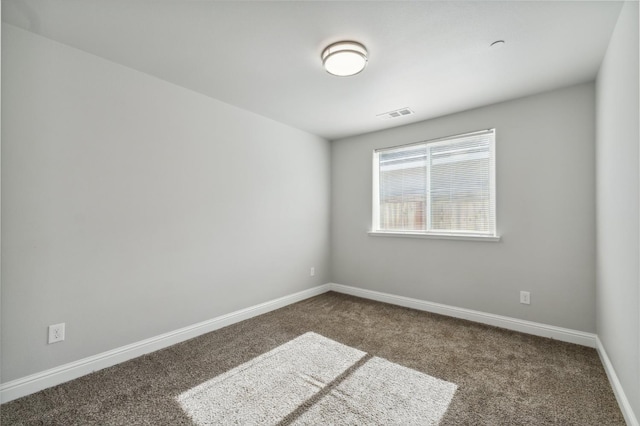 1061 Adell St, Madera, CA 93638 - spare room featuring dark colored carpet and baseboards