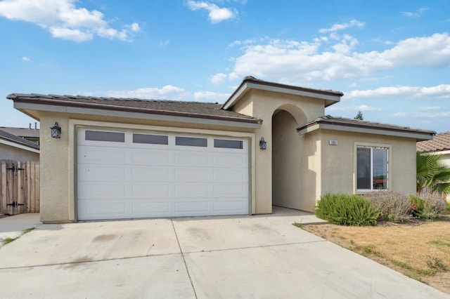 1061 Adell St, Madera, CA 93638 - view of front of property with concrete driveway, stucco siding, an attached garage, and a tile roof