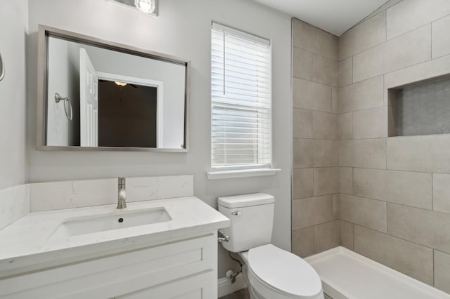 1061 Adell St, Madera, CA 93638 - full bathroom with vanity, toilet, and a tile shower