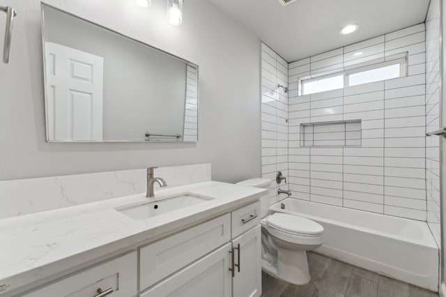 1061 Adell St, Madera, CA 93638 - full bathroom with vanity, wood finished floors, toilet, bathing tub / shower combination, and recessed lighting
