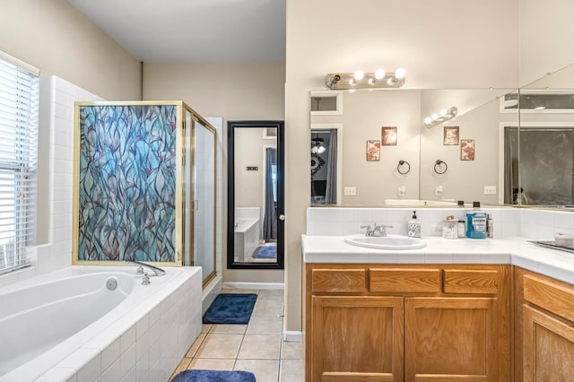 10033 N Baird Ave, Fresno, CA 93730 - full bath featuring a stall shower, a garden tub, vanity, and tile patterned flooring