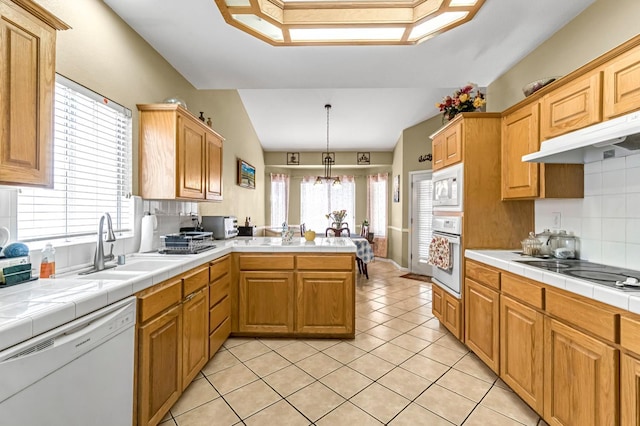 10033 N Baird Ave, Fresno, CA 93730 - kitchen featuring white appliances, a peninsula, decorative backsplash, light tile patterned flooring, and a chandelier