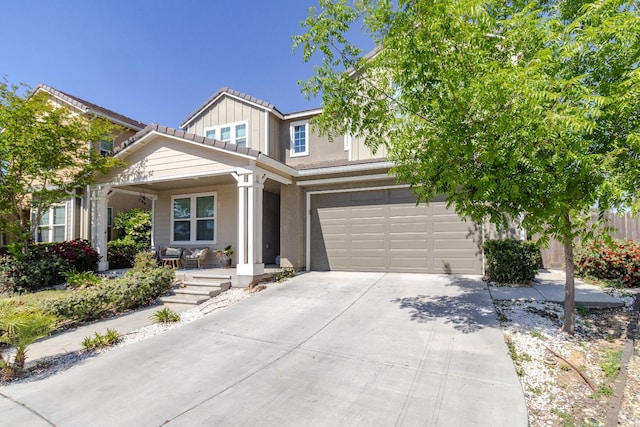 116 Meridian Ave, Madera, CA 93636 - view of front of property featuring a porch, concrete driveway, a tile roof, an attached garage, and stucco siding