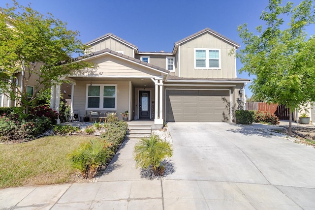 116 Meridian Ave, Madera, CA 93636 - view of front of property featuring a porch, concrete driveway, a garage, and board and batten siding