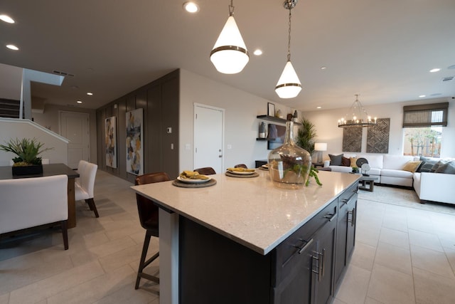 1157 Maclure Ave W, Madera, CA 93636 - kitchen featuring open floor plan, a center island, a kitchen breakfast bar, pendant lighting, and recessed lighting