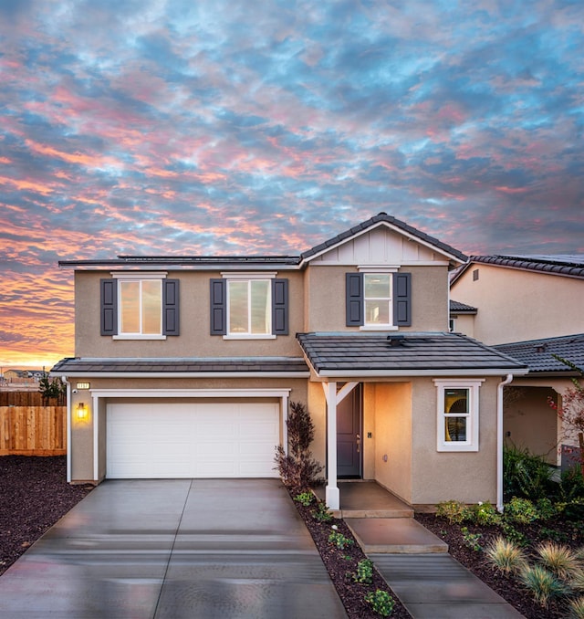1157 Maclure Ave W, Madera, CA 93636 - traditional home featuring stucco siding, concrete driveway, a garage, and a tile roof