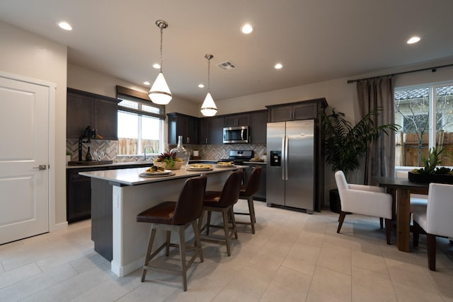 1157 Maclure Ave W, Madera, CA 93636 - kitchen with stainless steel appliances, tasteful backsplash, healthy amount of natural light, and recessed lighting