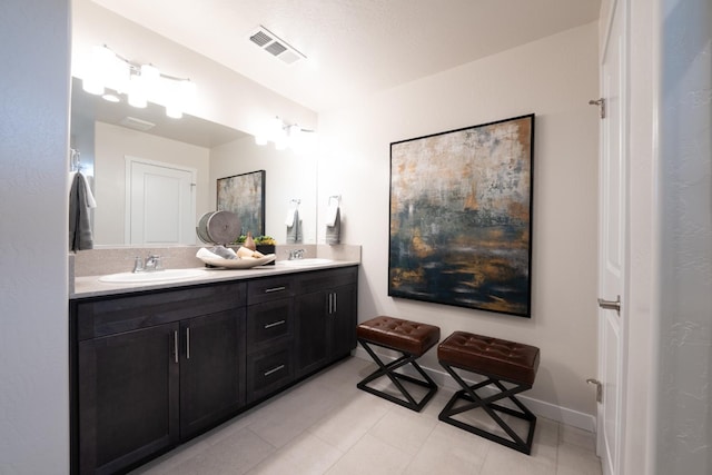 1157 Maclure Ave W, Madera, CA 93636 - bathroom featuring double vanity, tile patterned flooring, and baseboards