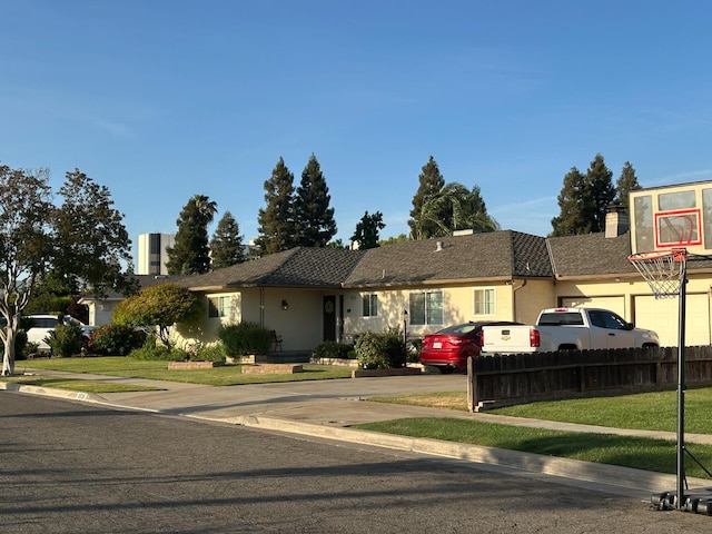 6538 N 4th St, Fresno, CA 93710 - ranch-style house featuring stucco siding, a chimney, and an attached garage