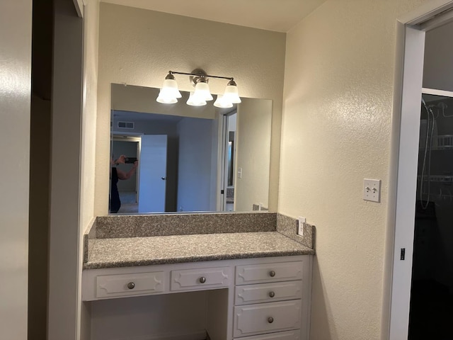 6538 N 4th St, Fresno, CA 93710 - bathroom with a textured wall and vanity