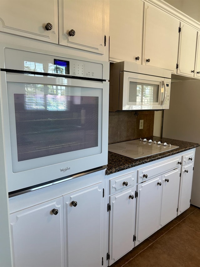 6538 N 4th St, Fresno, CA 93710 - kitchen with white appliances, white cabinetry, dark stone counters, and dark tile patterned floors