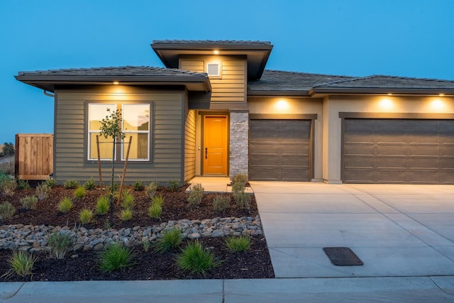 8152 Creek Vw, Friant, CA 93626 - prairie-style home featuring a garage, driveway, and a tile roof