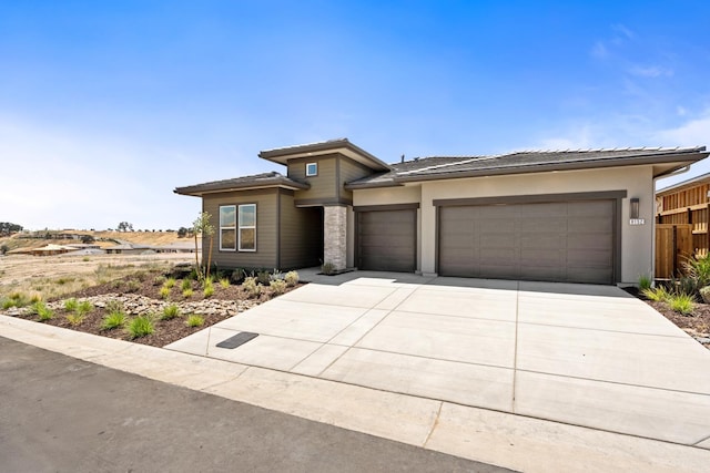 8152 Creek Vw, Friant, CA 93626 - prairie-style home with an attached garage, driveway, stucco siding, and a tile roof